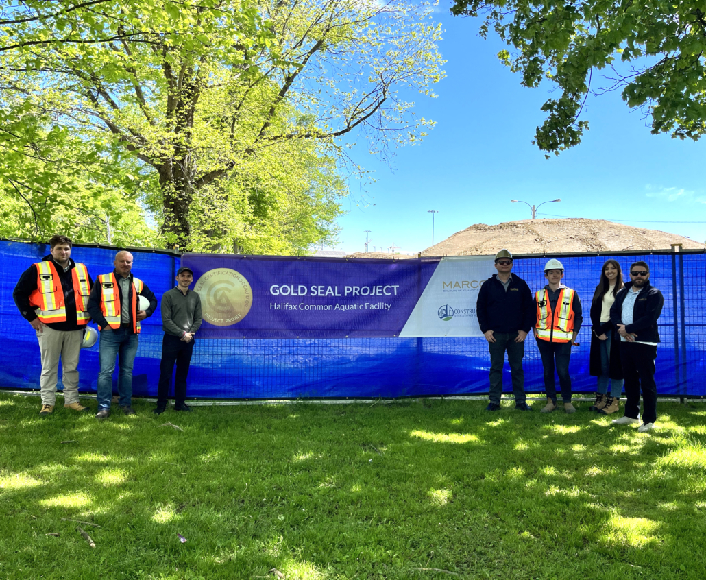 CANS and Marco appear in the photo with Gold Seal Designated Project banner in background.